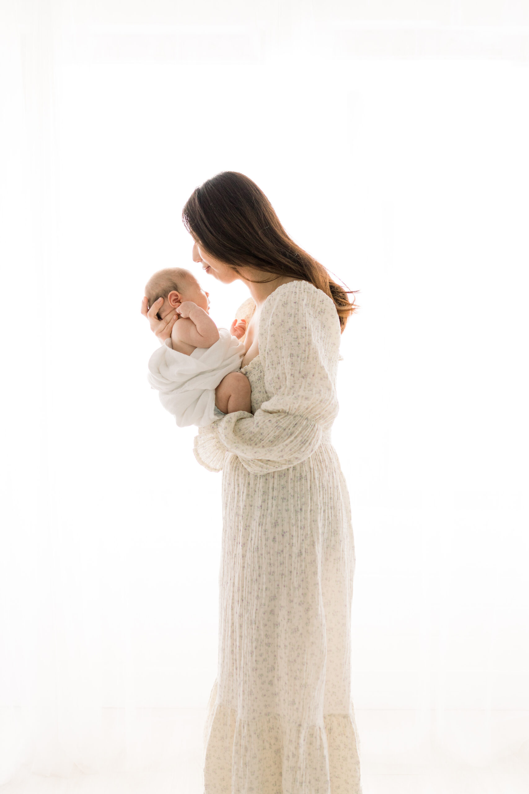Photo of mom holding baby at a newborn photography burlington studio session at the Nook by Ericka Ana Photography