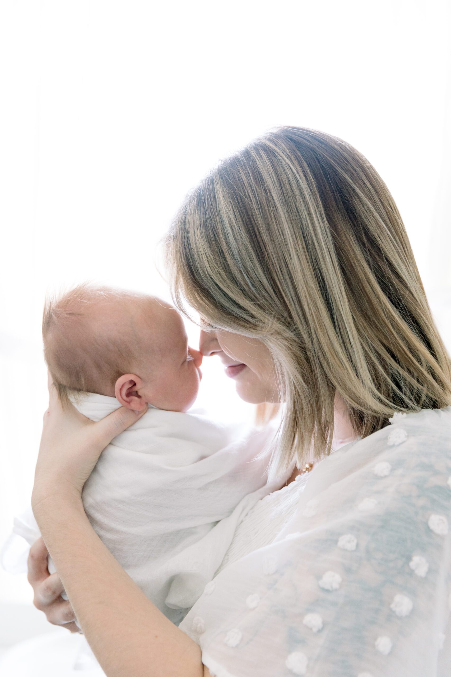 Photo of mom and baby against window light by ERICKA ANA Photography